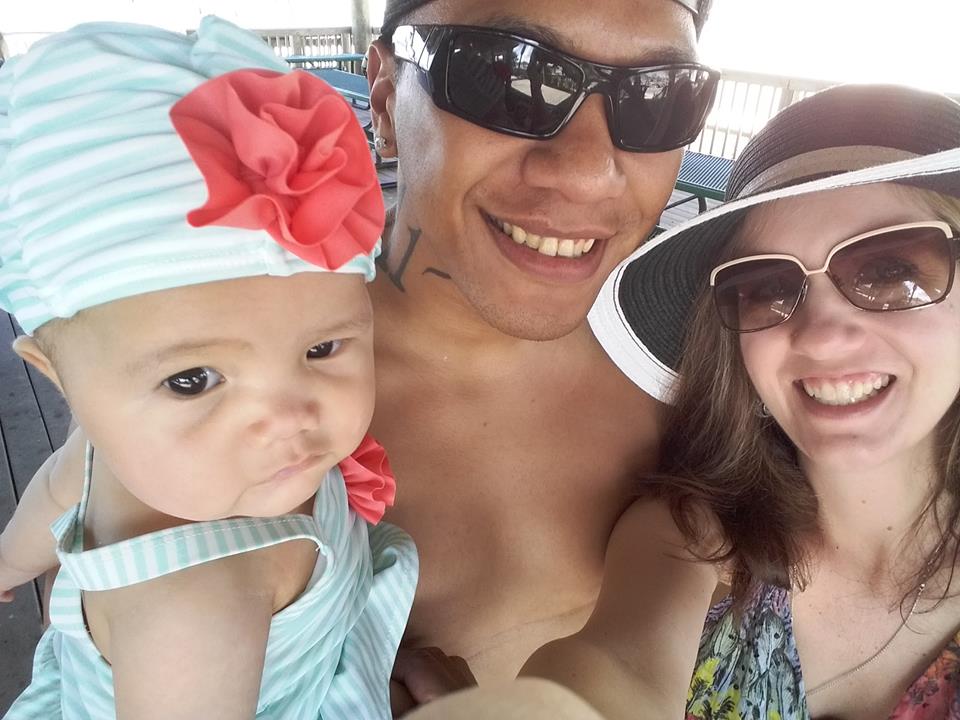 family beach day with mom dad and baby
